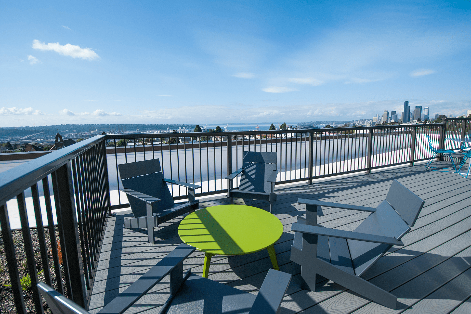 The communal space at the top of the McClellan building has several seating areas and a view of Seattle and surrounding water.